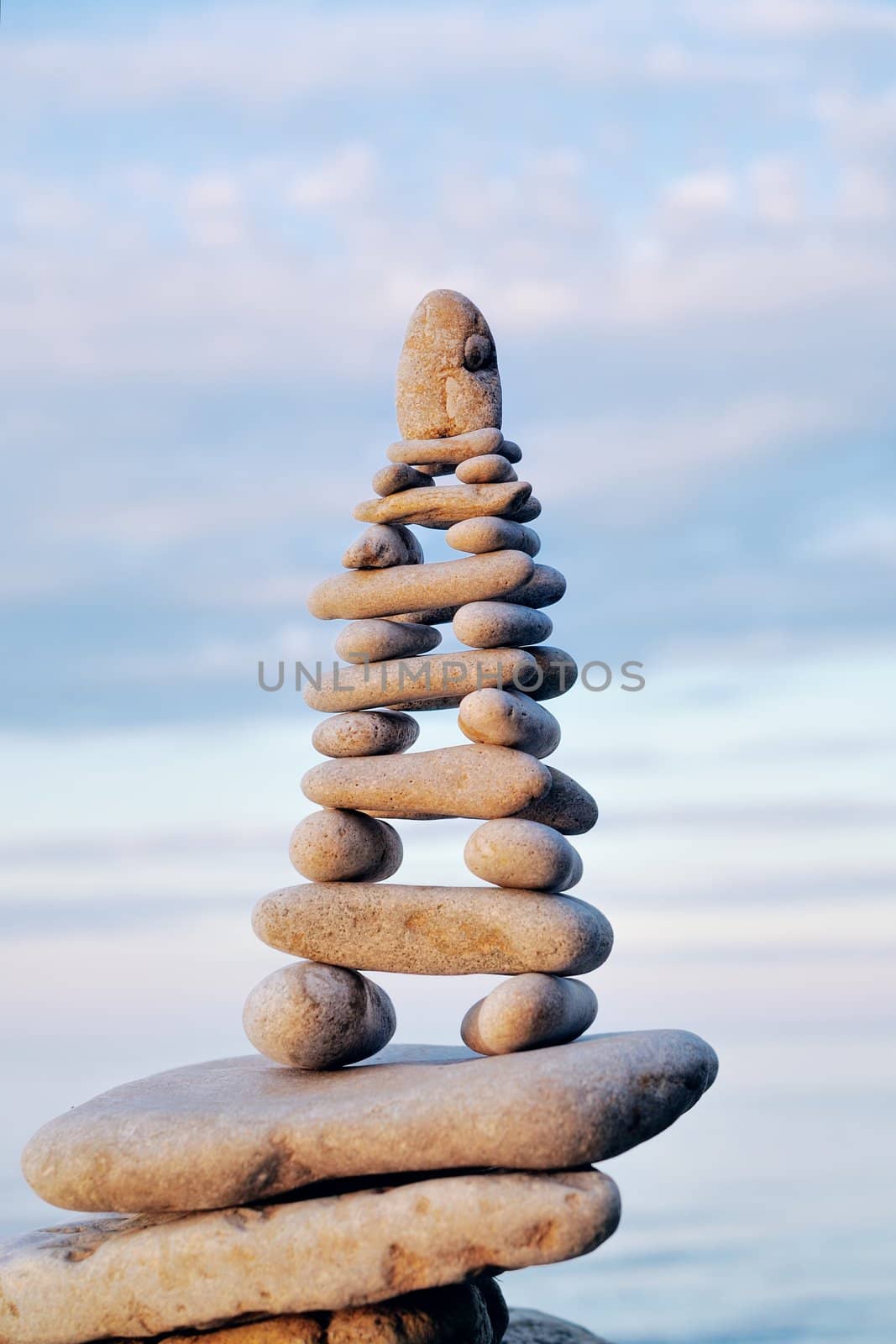 Pile of pebbles as pyramid against the background of sky