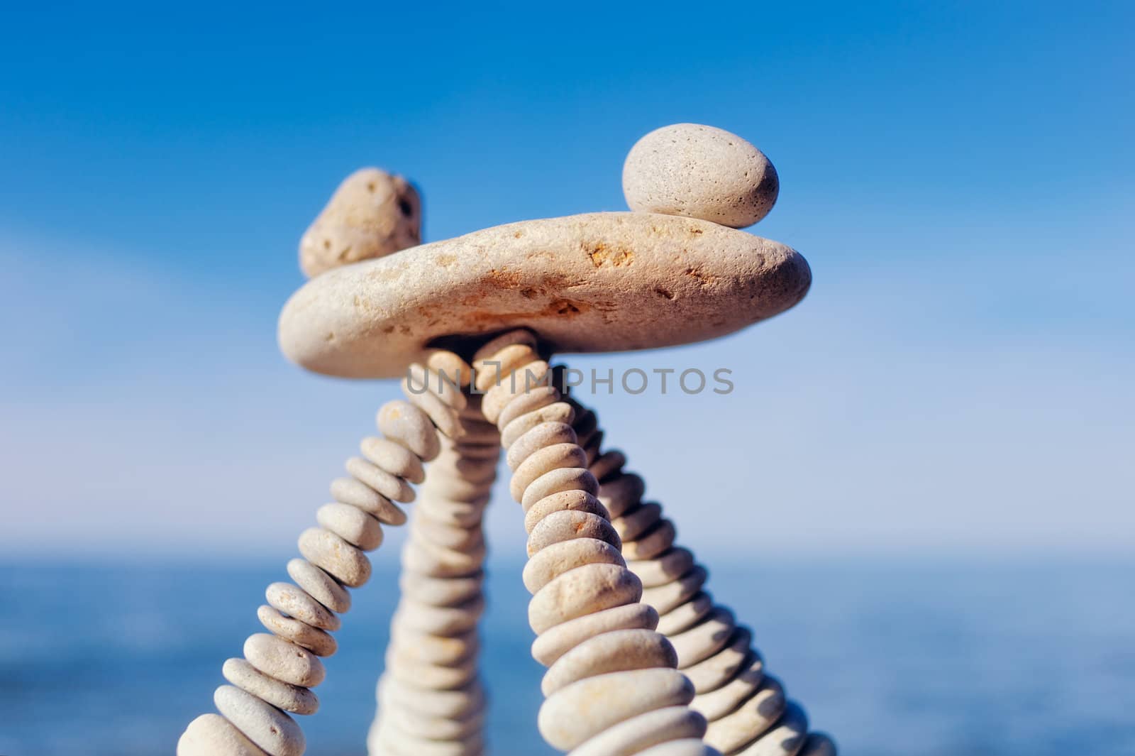 Balancing of white stones on the top of pyramidal stack