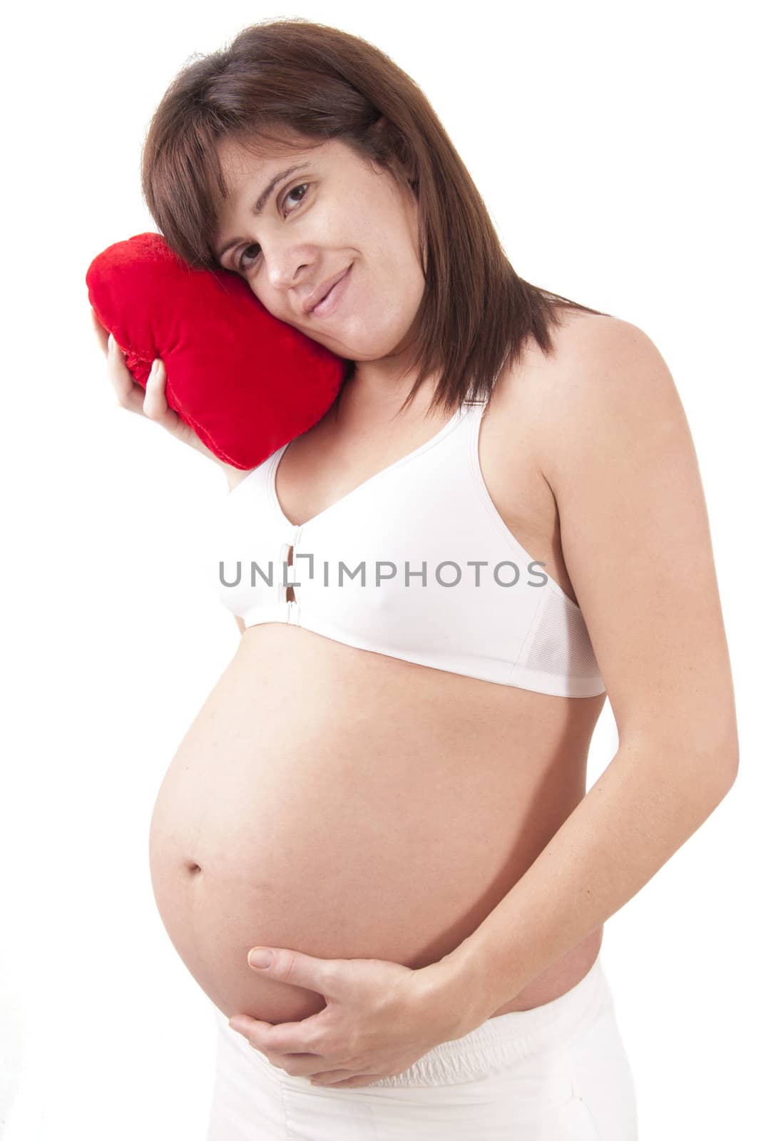 Pregnant woman hugs her belly