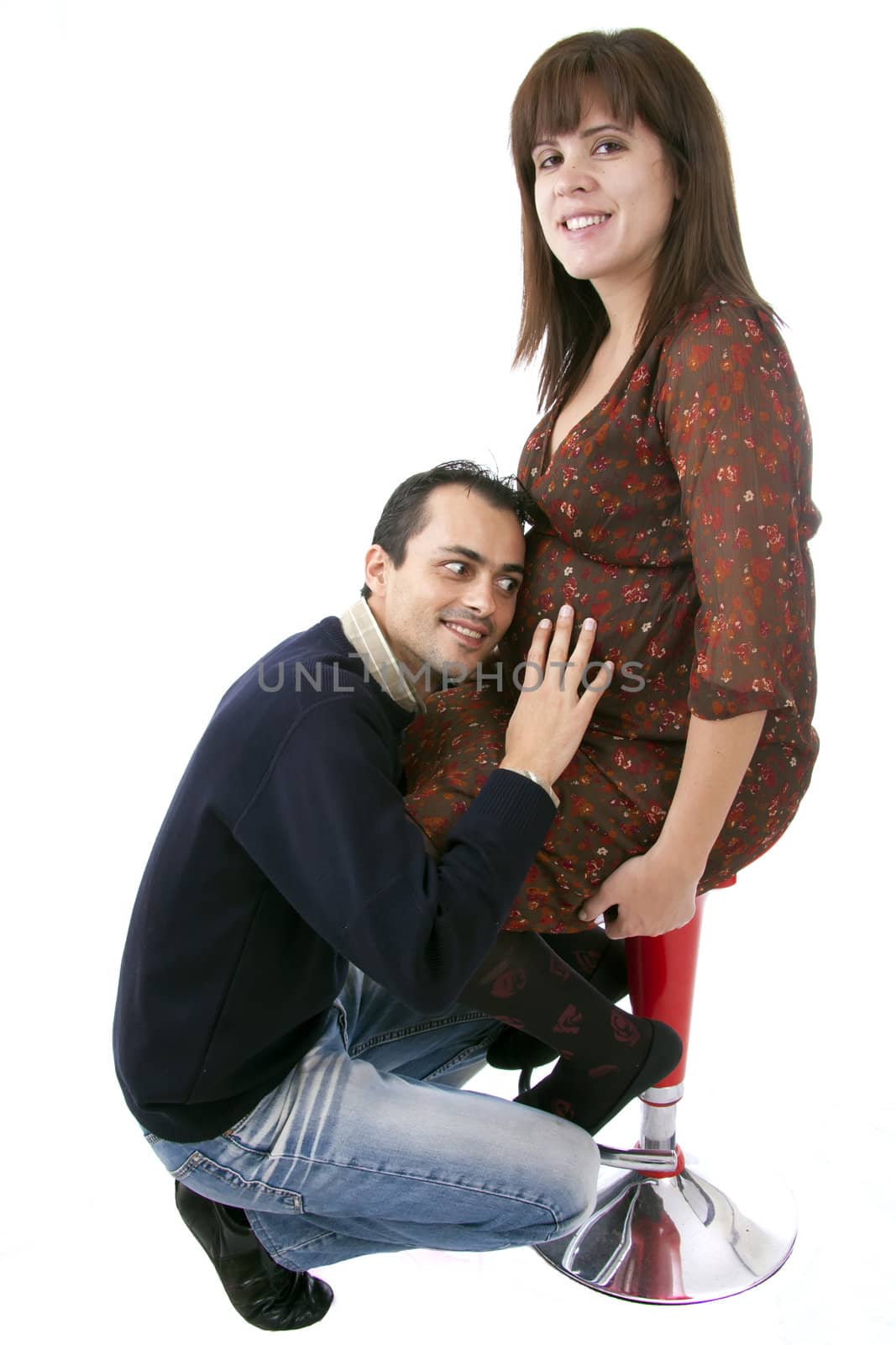 husband listening to the heartbeat of the baby