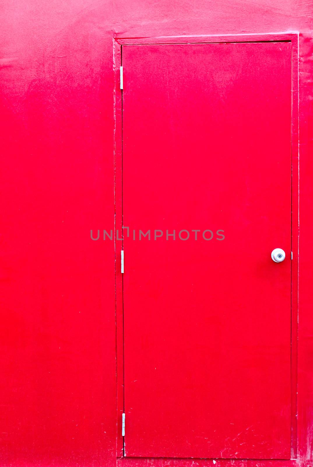 Closed red door with red wall