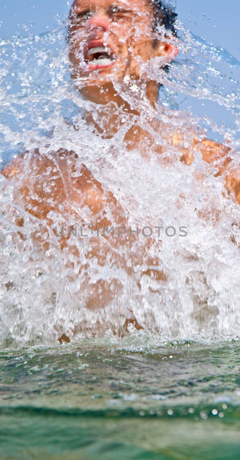 man coming out of sea dive, splashing water, motion