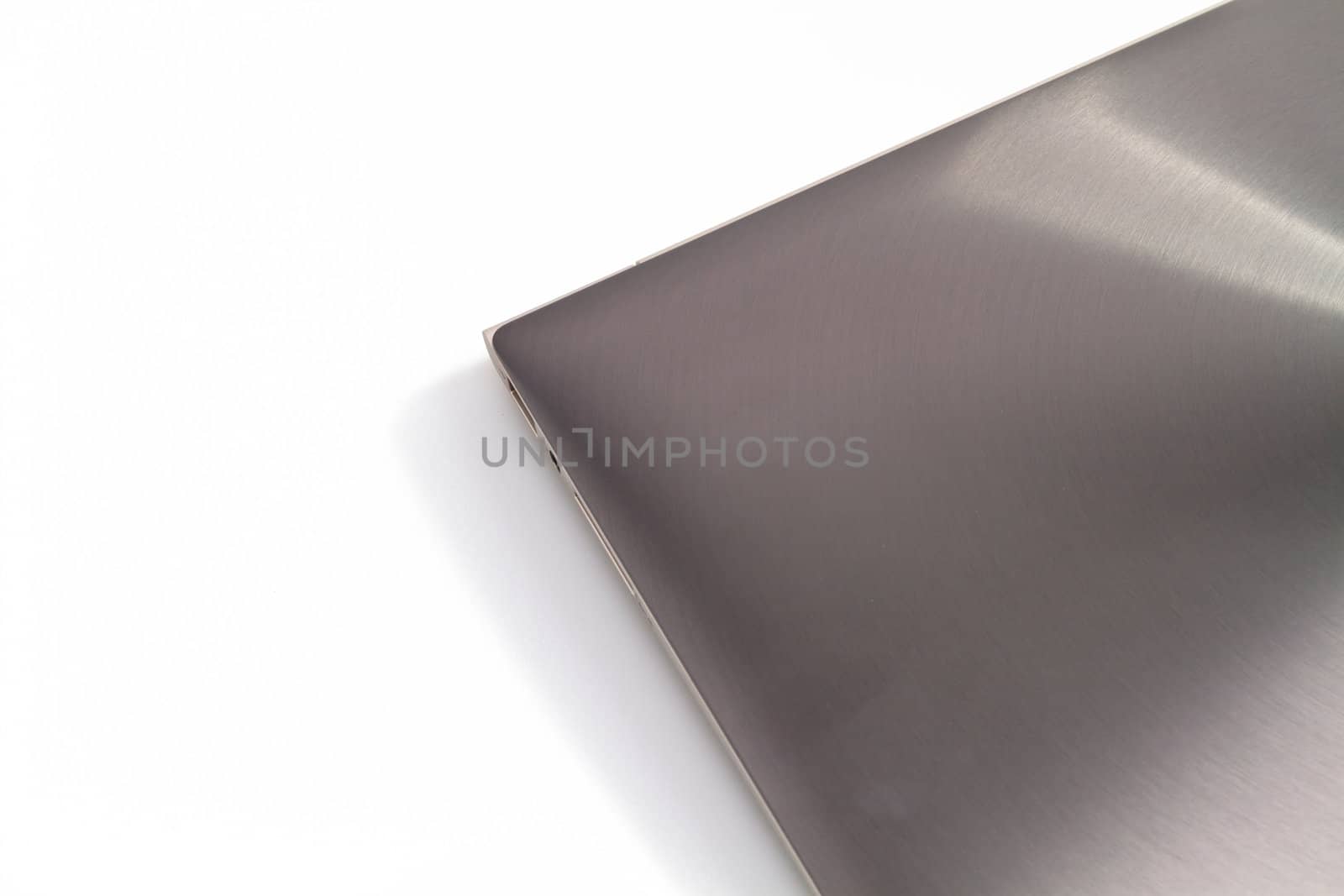 top view of a modern metal-lid laptop on white background for abstract background
