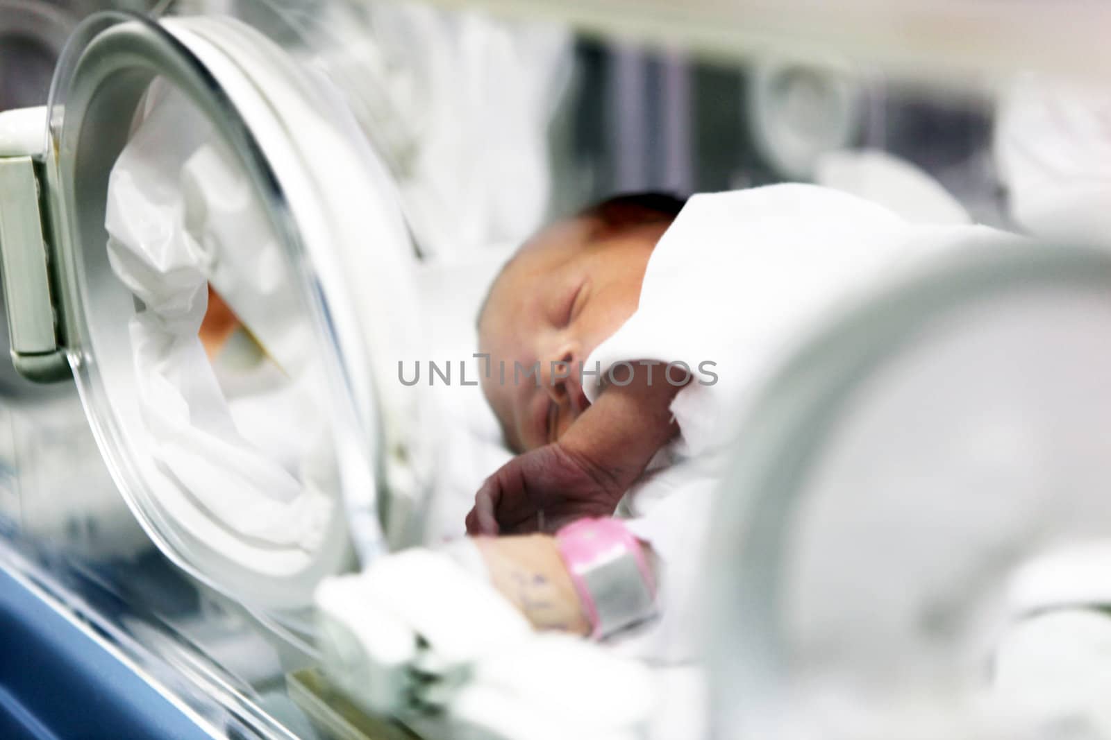 Newborn baby inside incubator