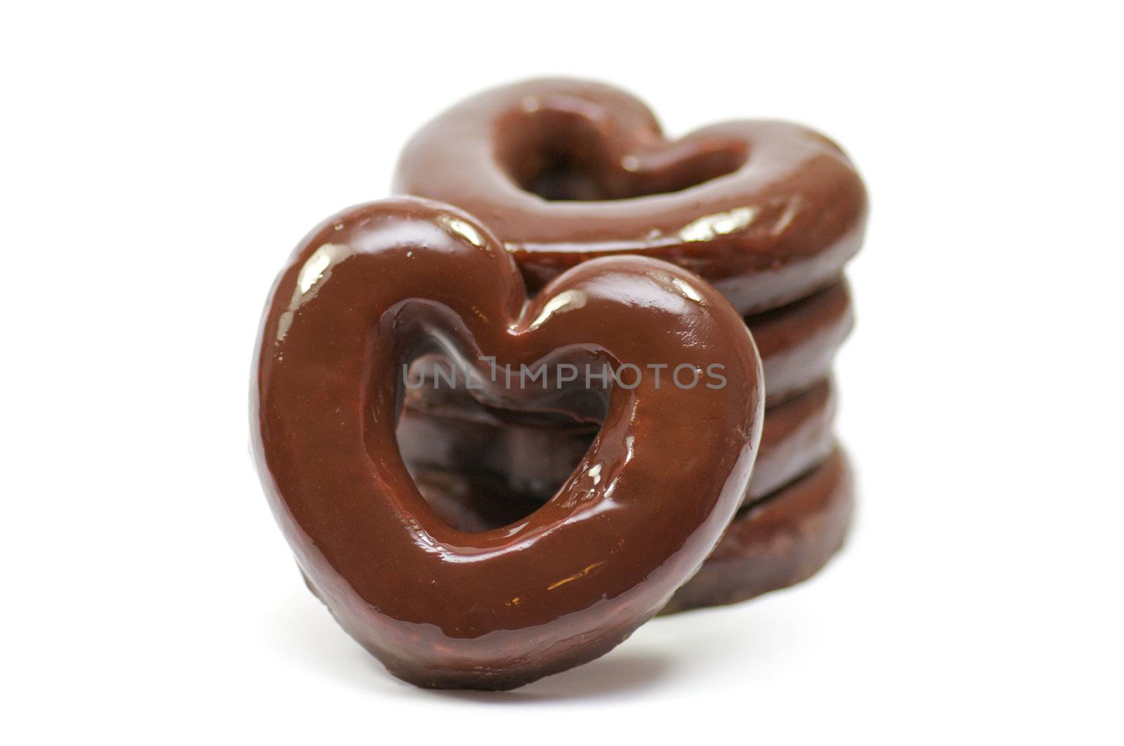 Chocolate hearts-rings in glaze isolated in white background