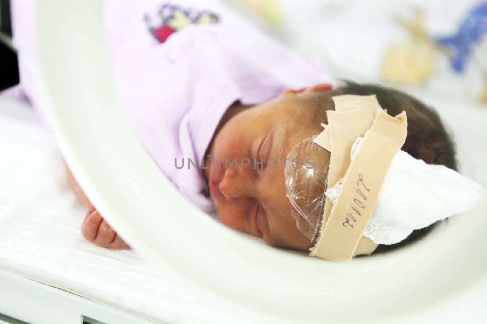 Newborn baby inside incubator