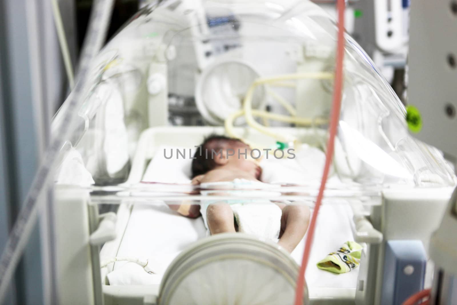 Newborn baby inside incubator