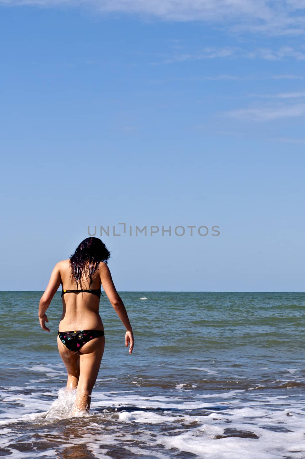 Girl on a deserted beach in a bay in Ecuador