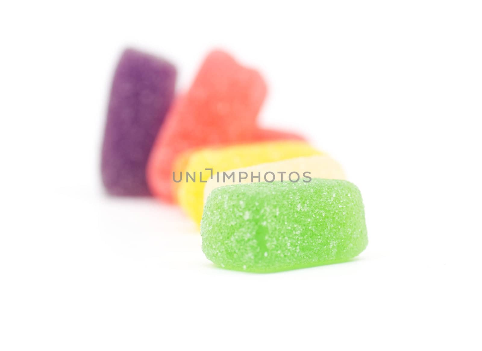 Multi colored fruit jelly candy on white background