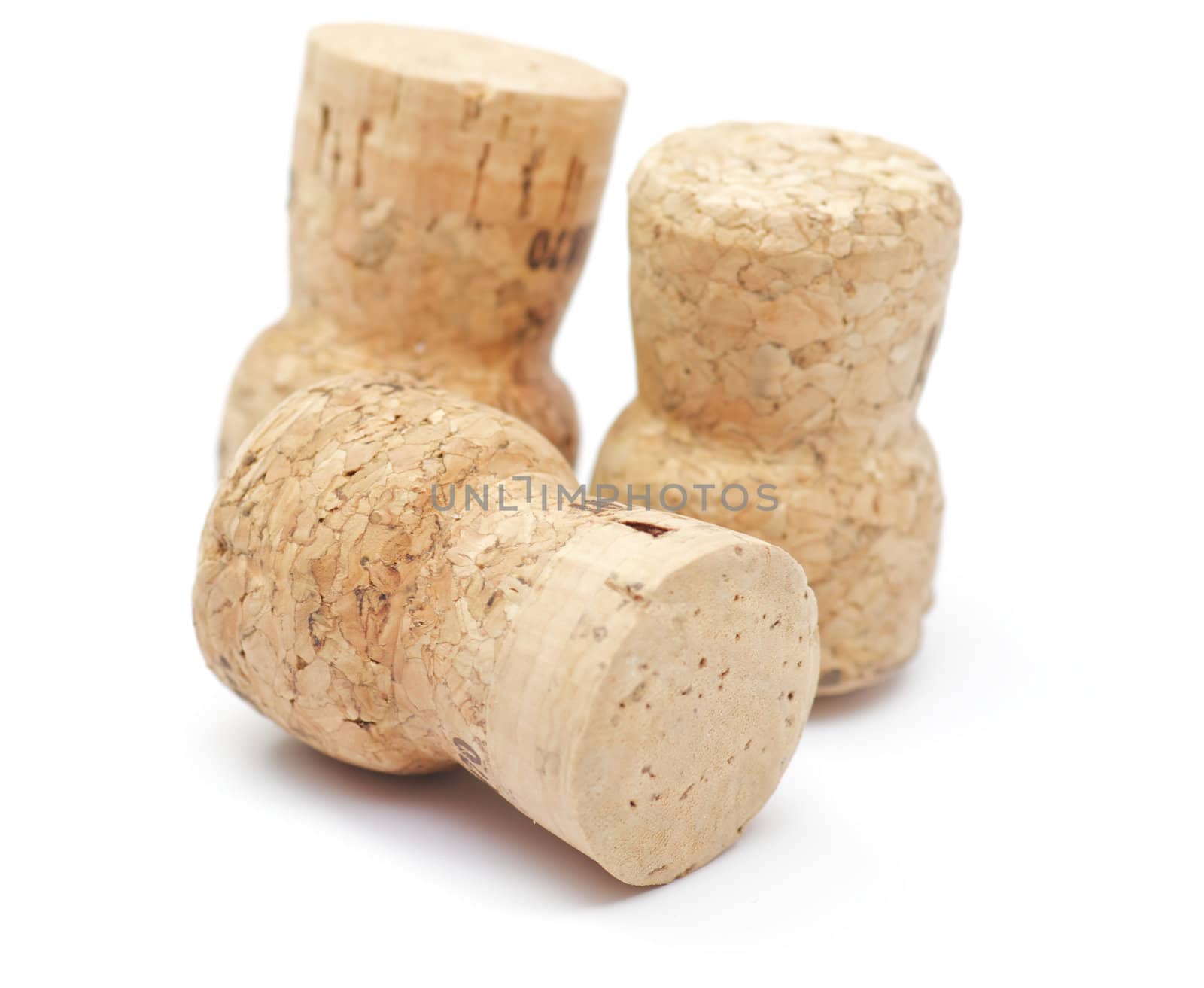 Three Cortical champagne corks on white background