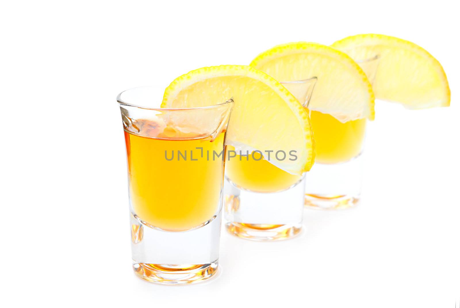 Gold Tequila with lime slice isolated on white background 