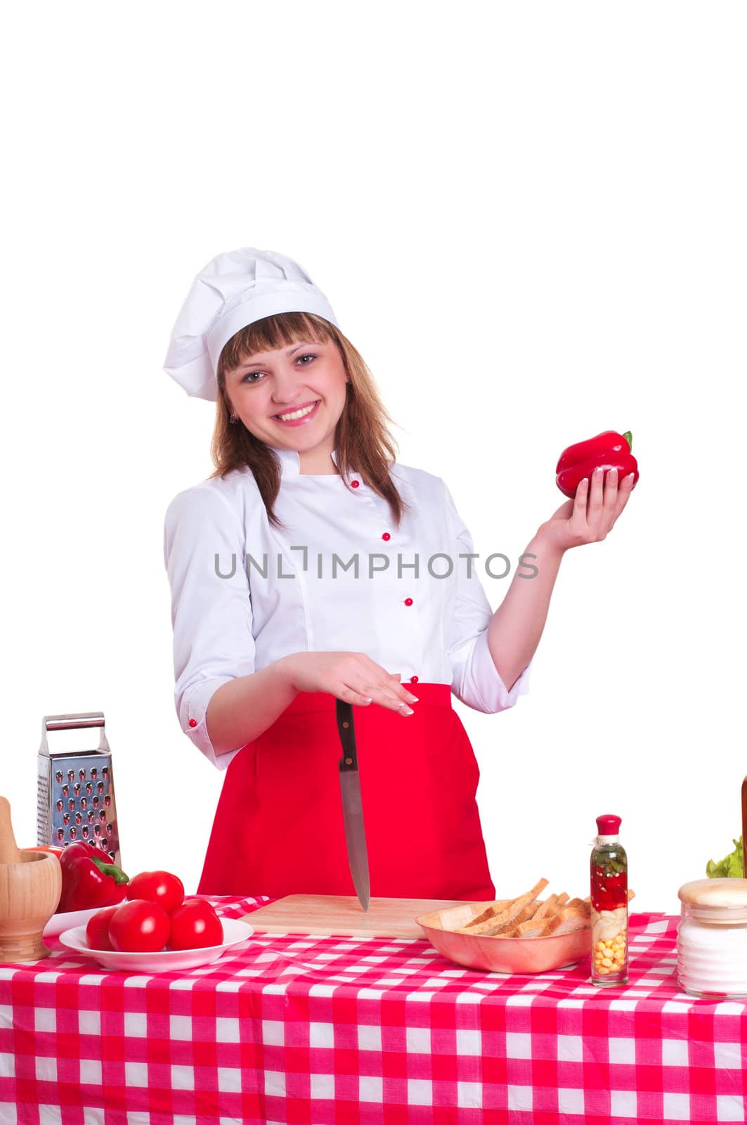 attractive woman cuts vegetables, keeps vegetables, smiling and looking into the camera