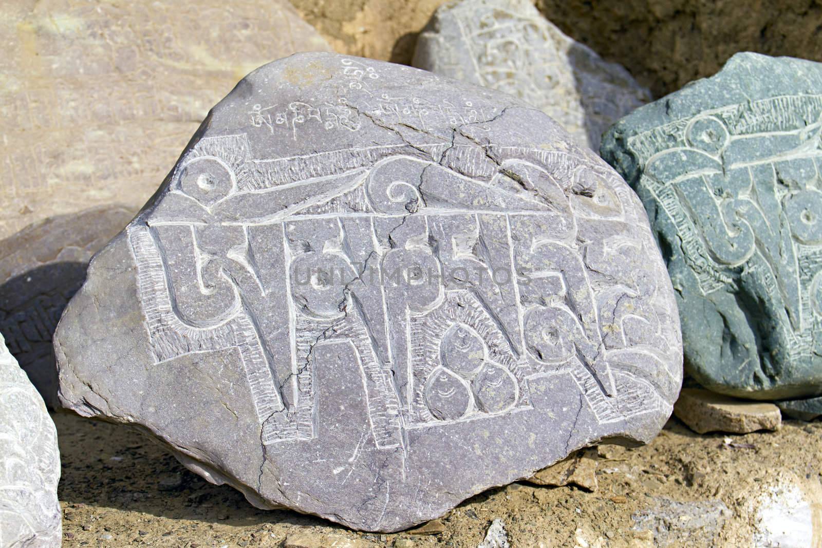 	
stones in the mountains with written on them Buddhist mantras