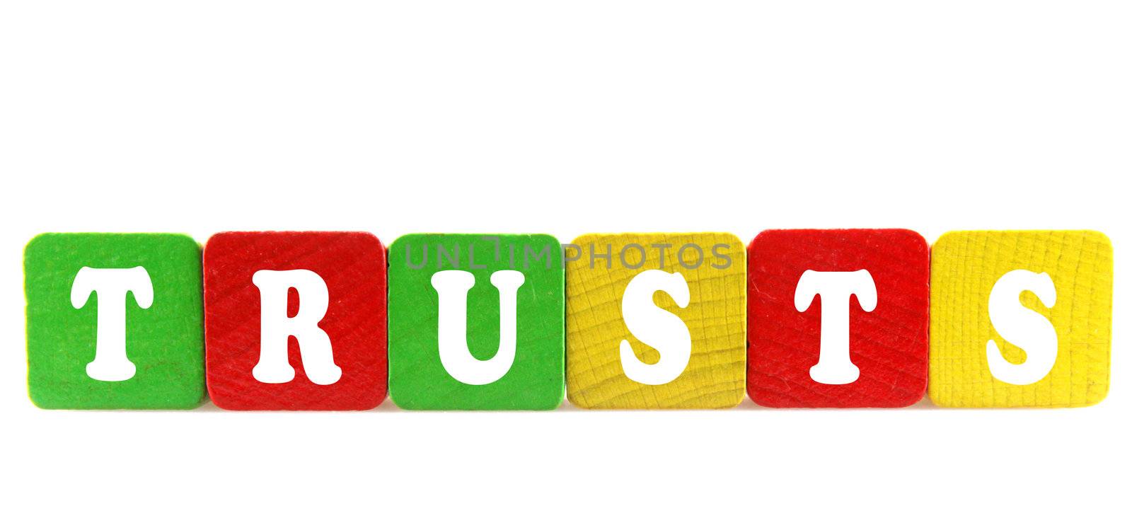 trusts - isolated text in wooden building blocks