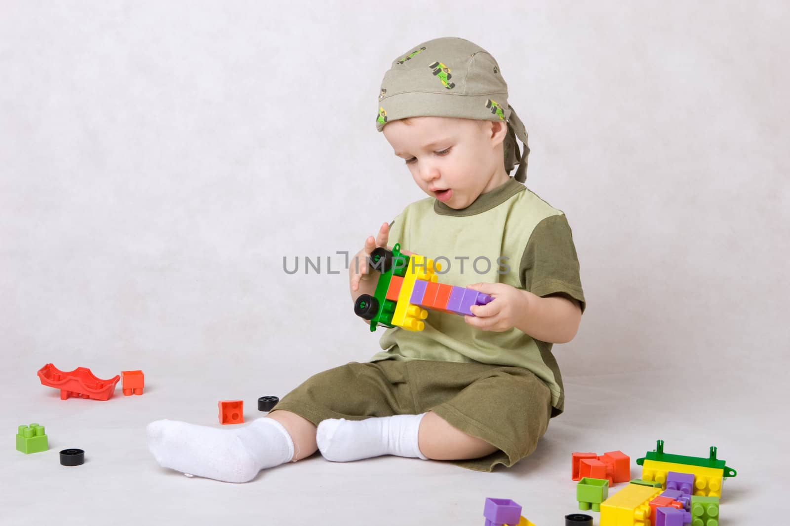 a boy of one year plays designer cubes