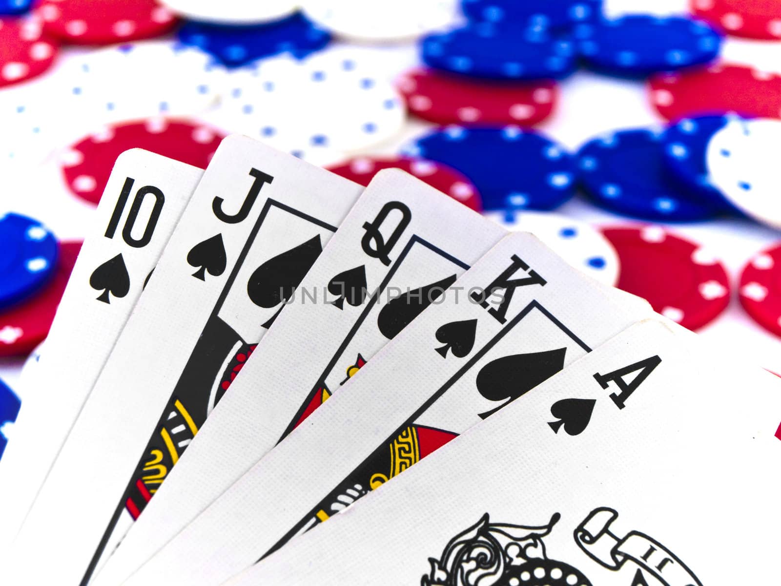 Red White and Blue Poker Chips and Royal Flush on White Background