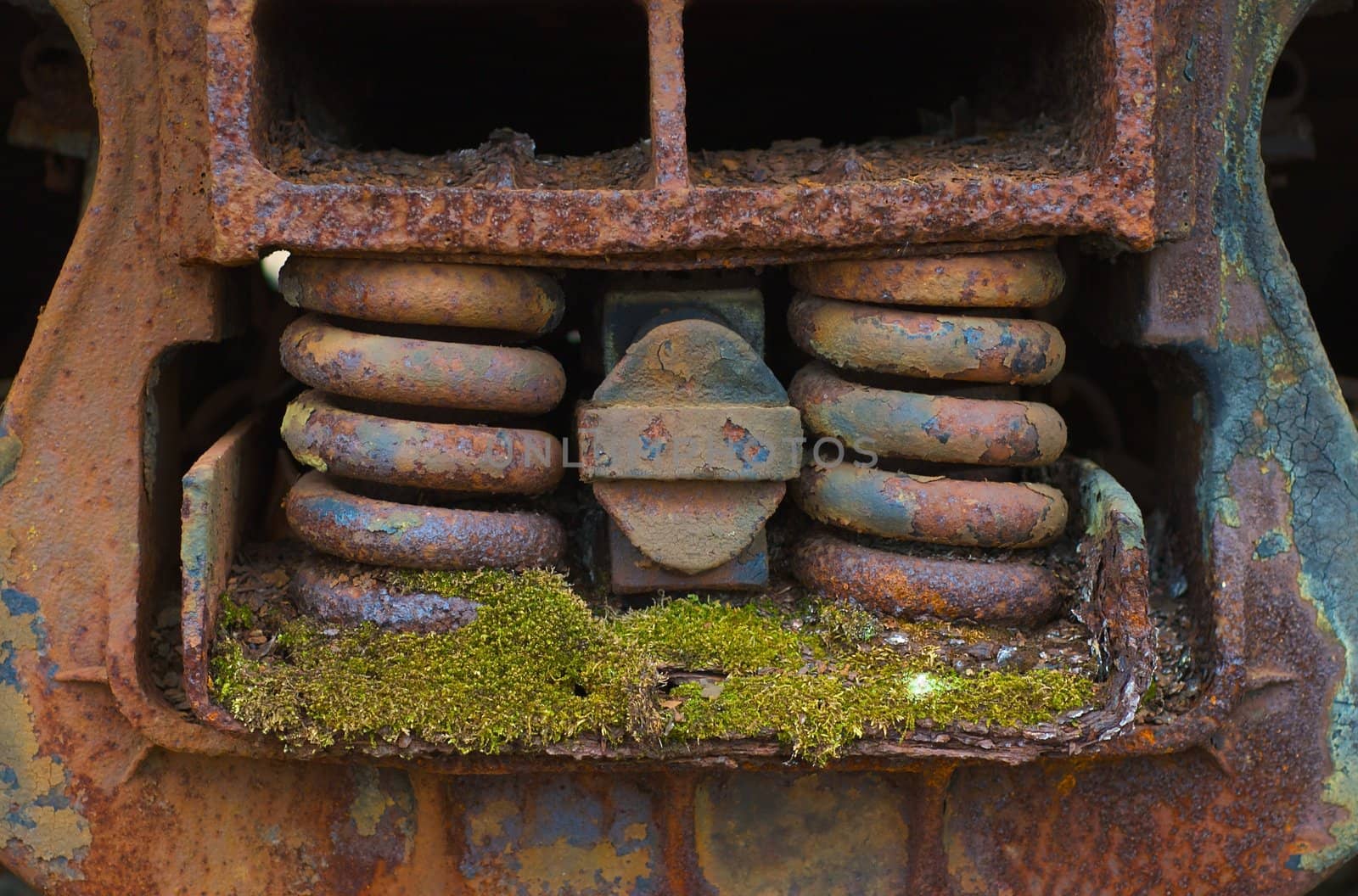 Detail of a train suspension system in disrepair.