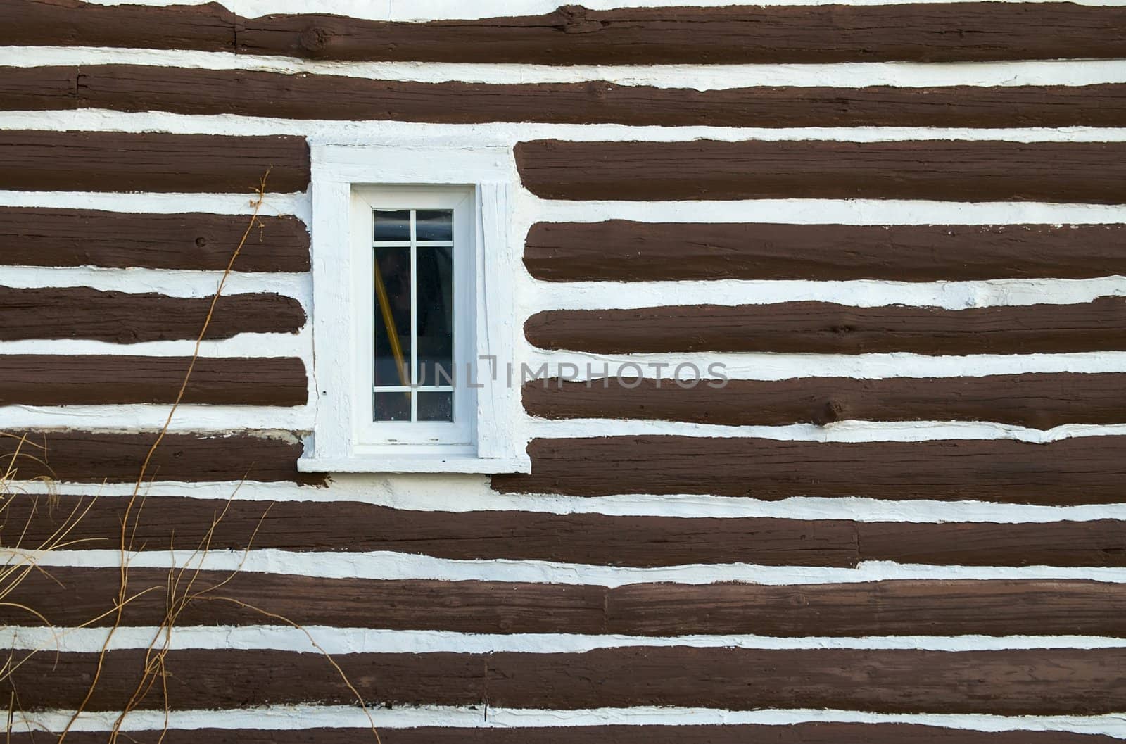 Cabin Window on the side of a log cabin.