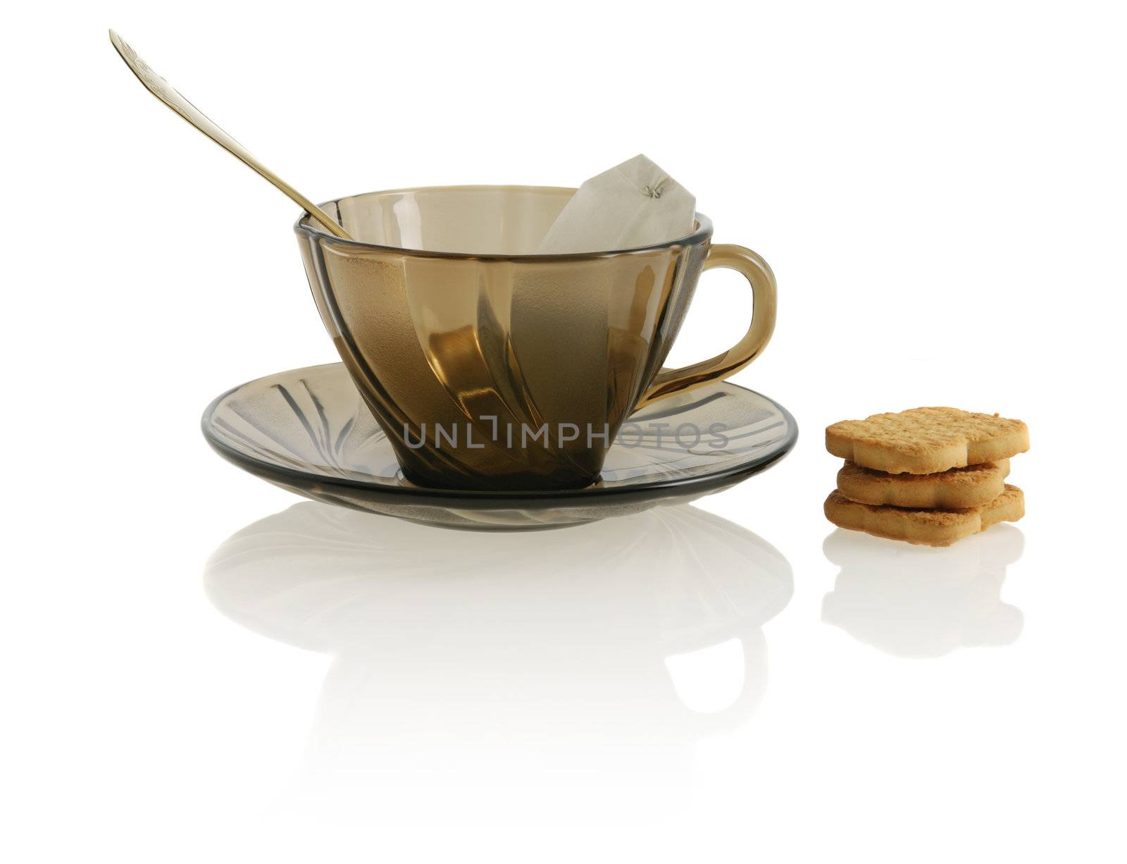 empty glass transparent cup with spoon,  cookie, anf package tea by galdzer