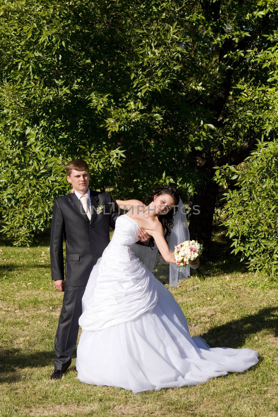 bride and groom dance in the park