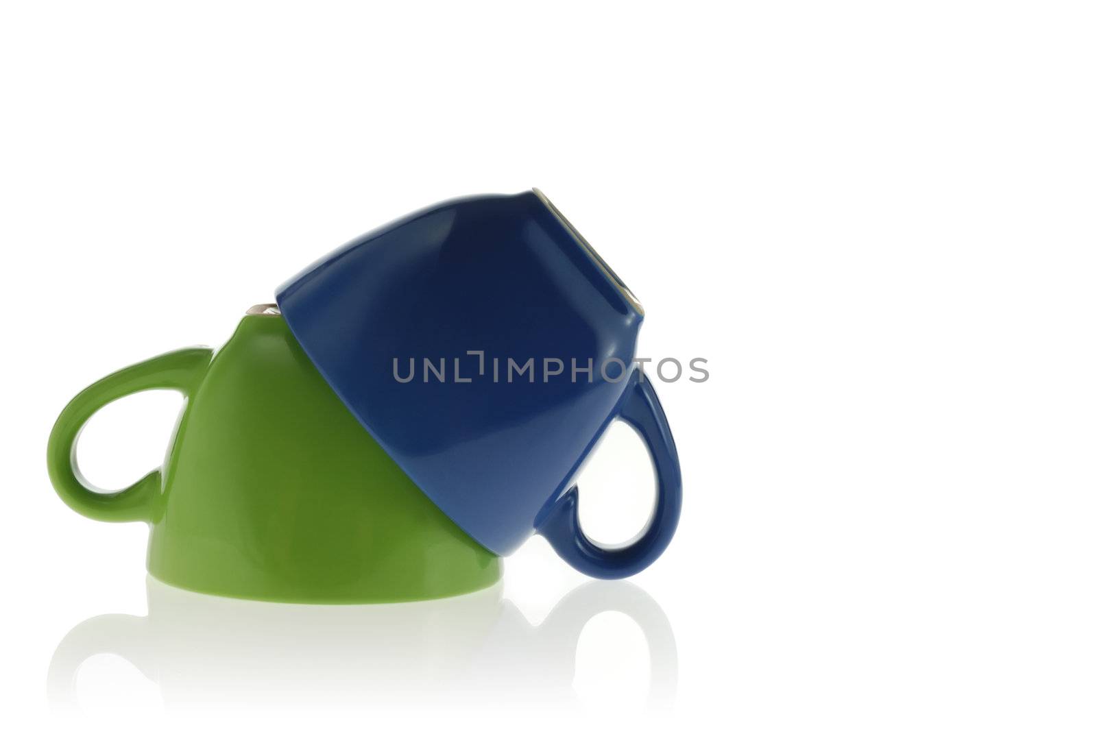 Two cups. Green and dark blue color turned to top a bottom