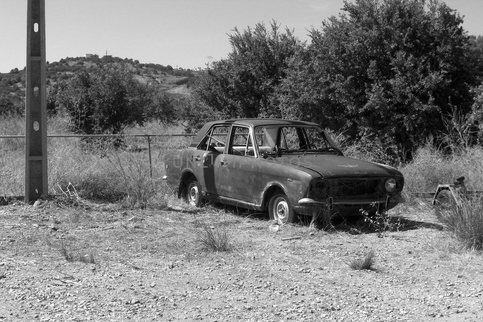 black and white image of an old vintage car wreck