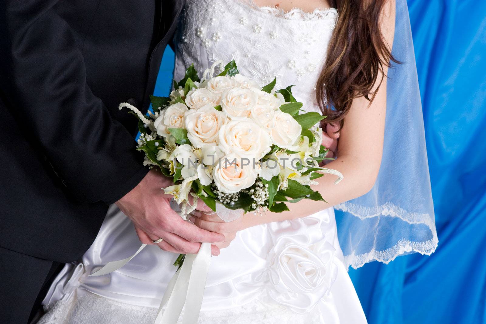 a beautiful rose bouquet in the hands of the bride and the groom by vsurkov