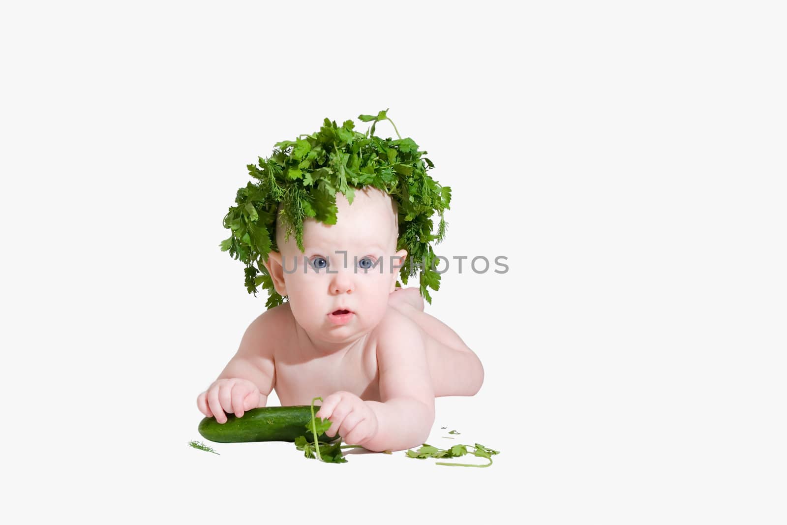 Small child with vegetables on white 