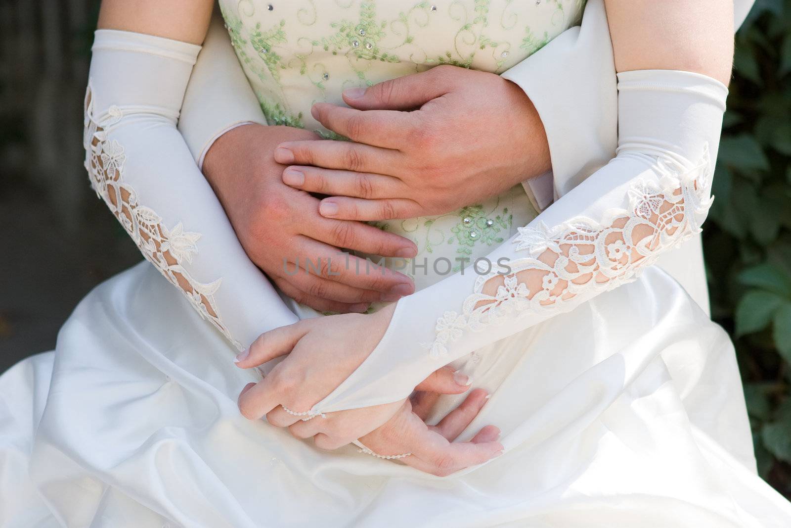 groom embraces the bride