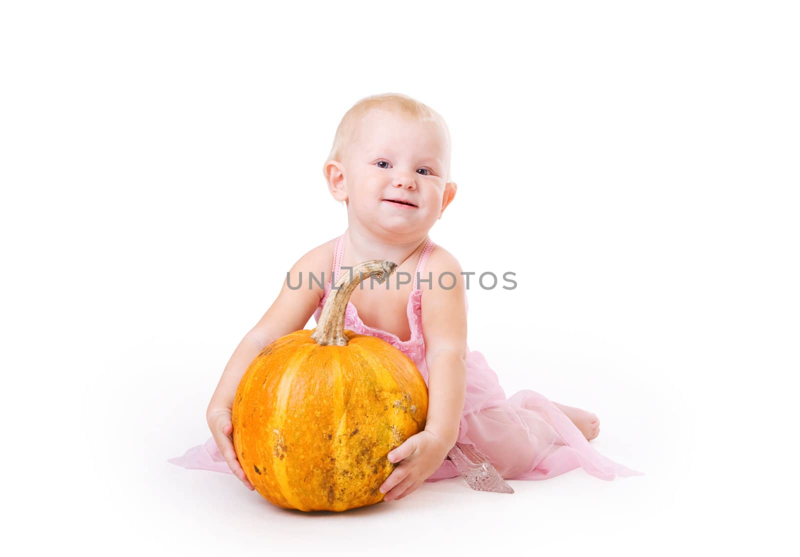 smiling little girl embraces a pumpkin by vsurkov