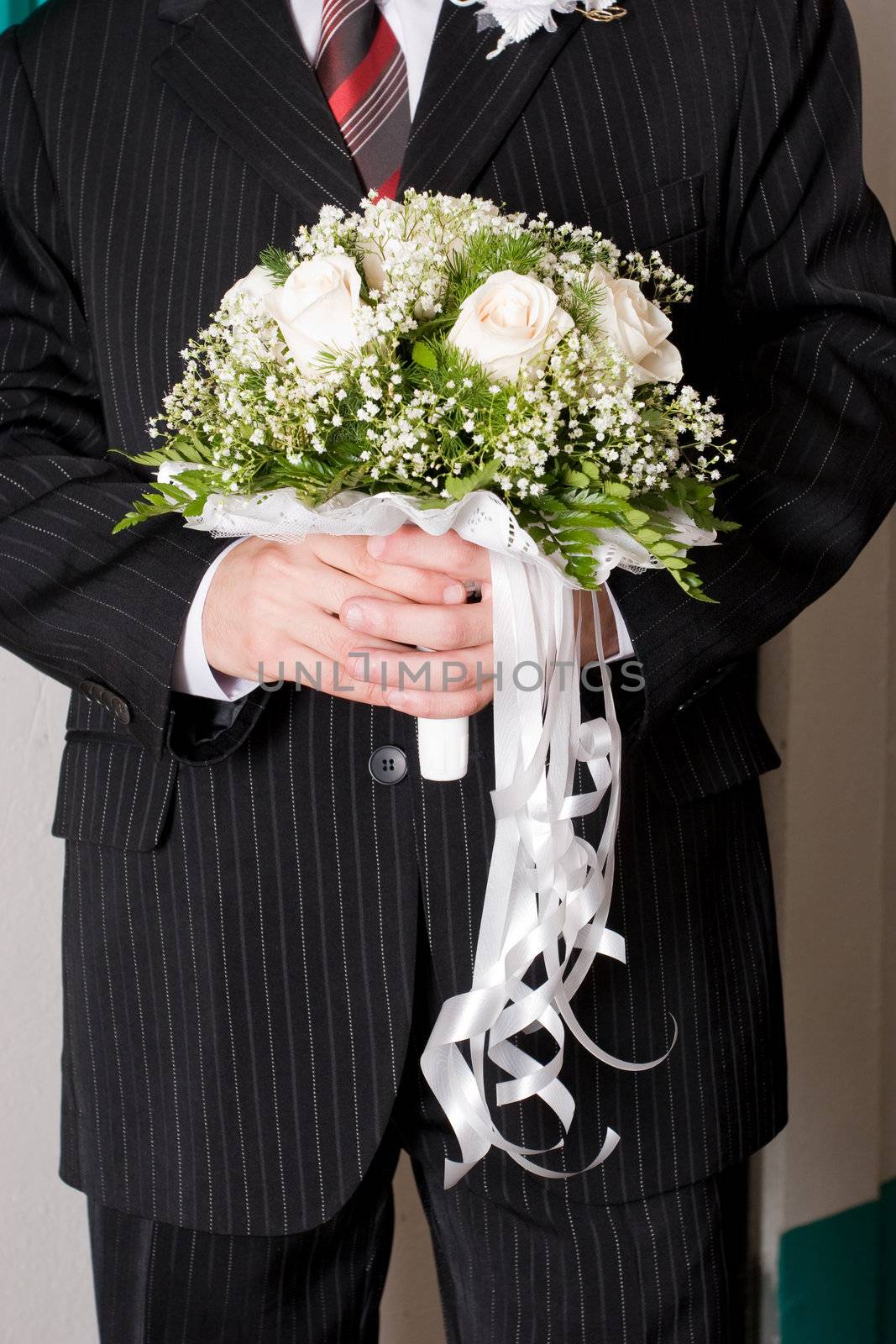 a beautiful flower bouquet in the hands of a man