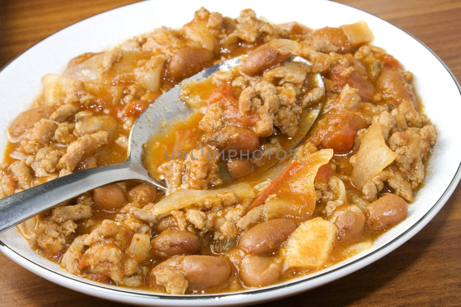 Bowl of chili with spoon ready to eat or serve