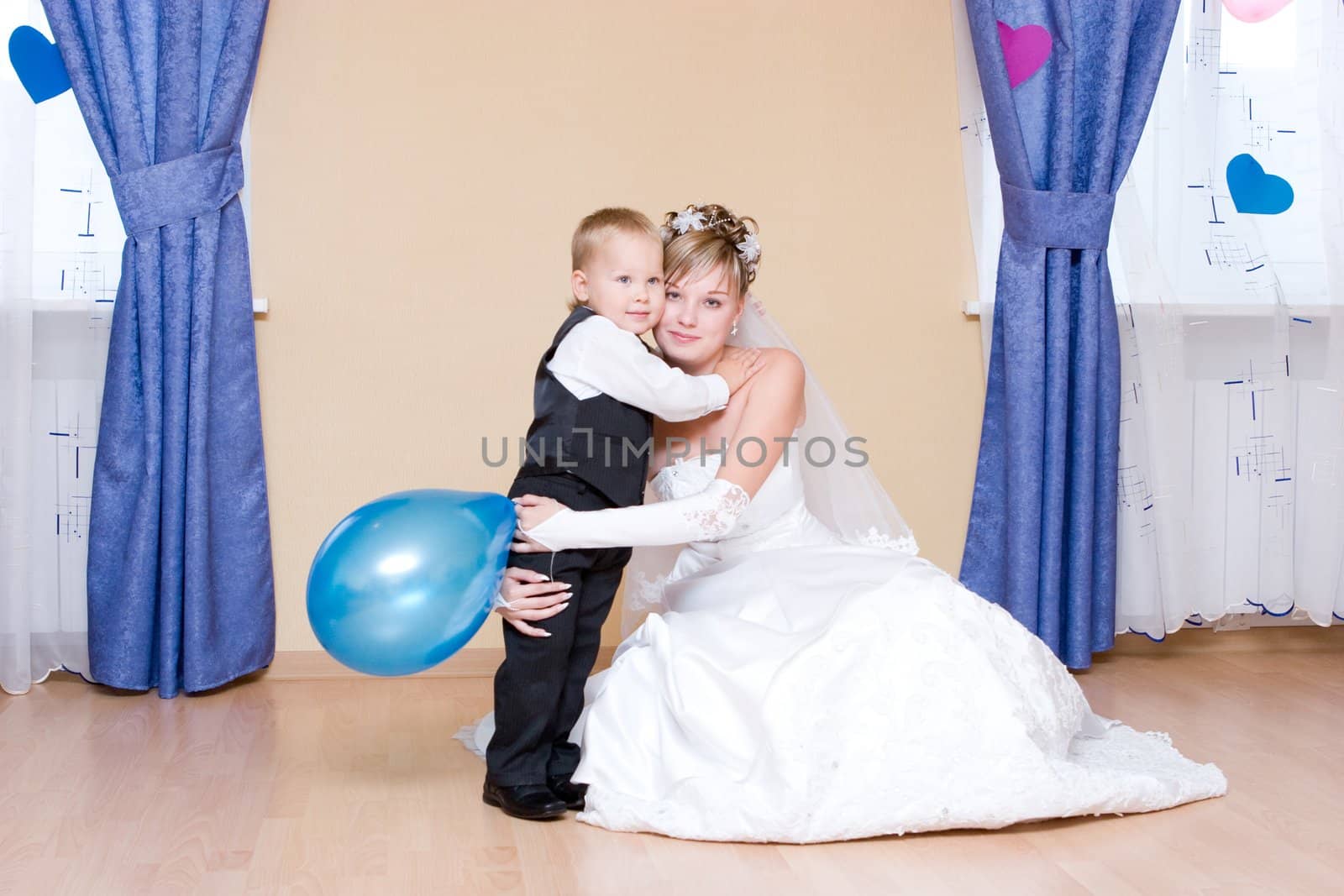 The beautiful bride embraces her little brother