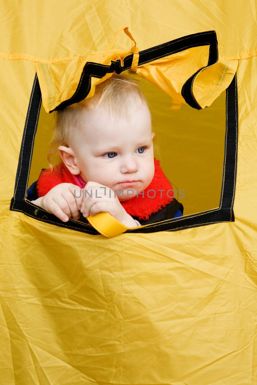 small girl looks out of the window tent