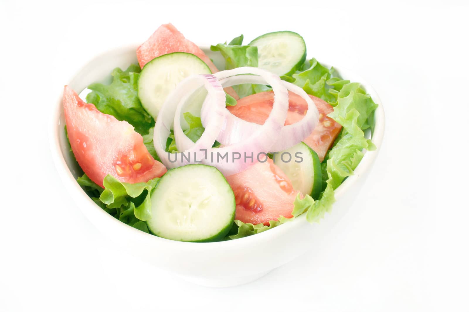 House salad in a white bowl and shot on a white background.