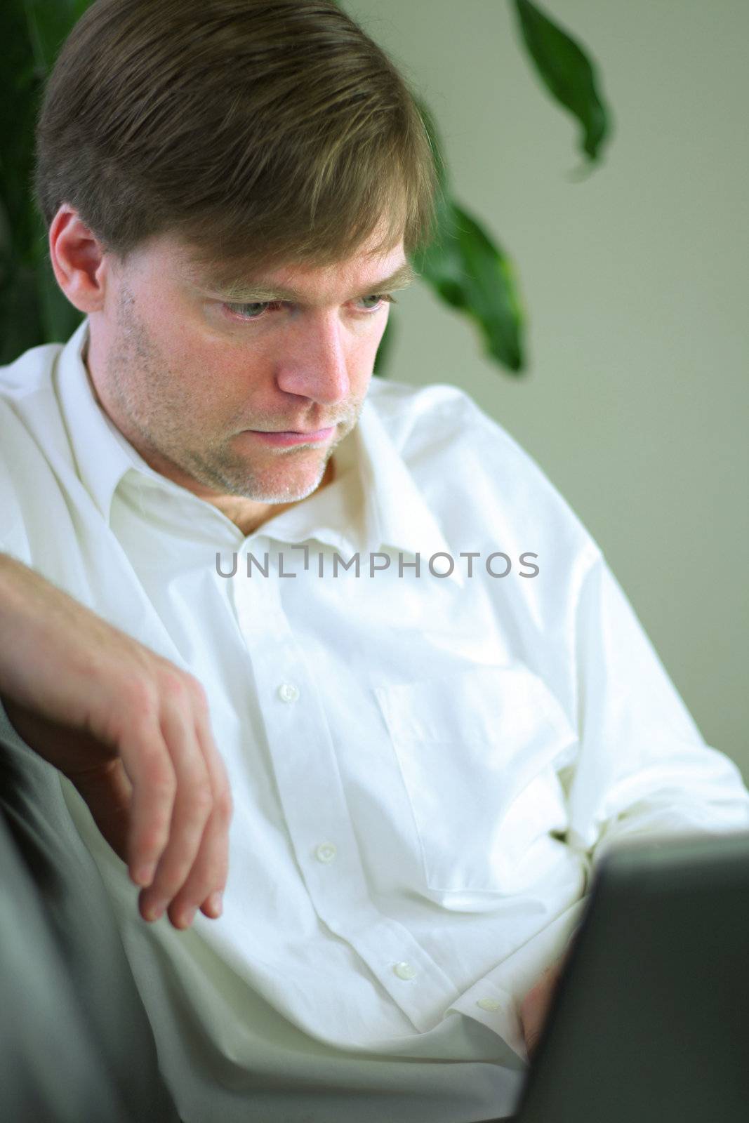 Handsome businessman working on laptop