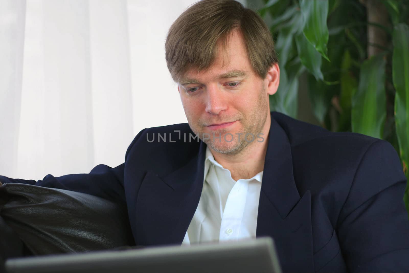 Handsome businessman working on laptop