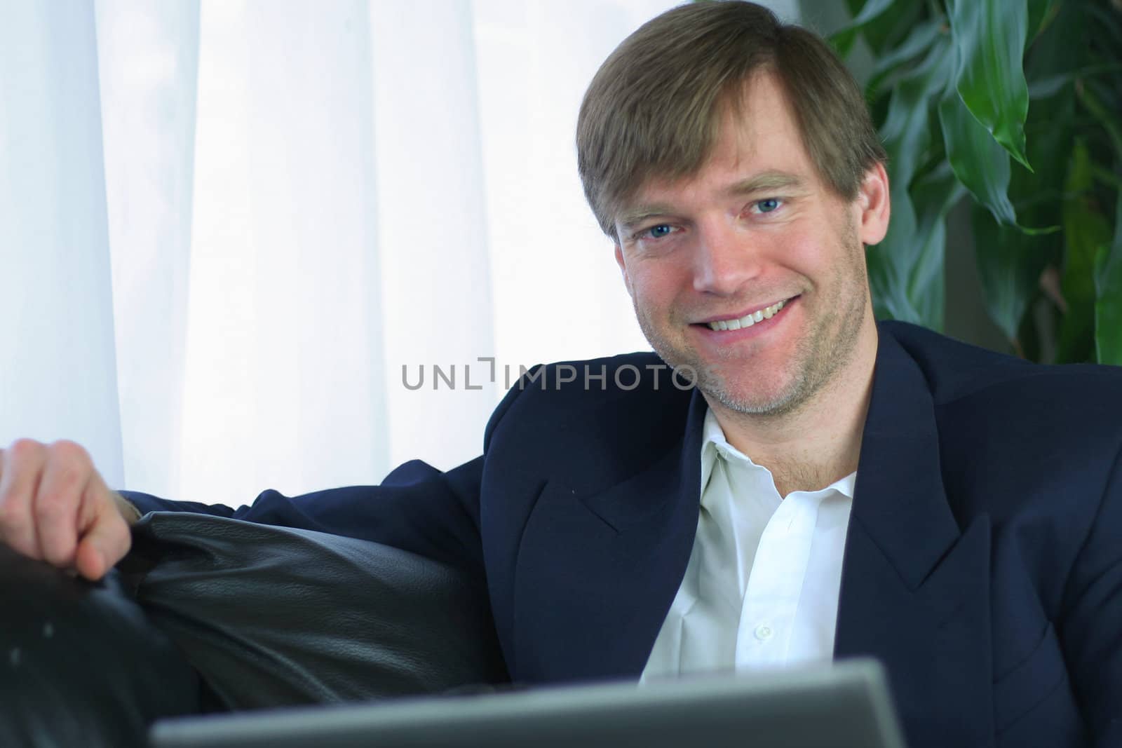 Handsome businessman working on laptop