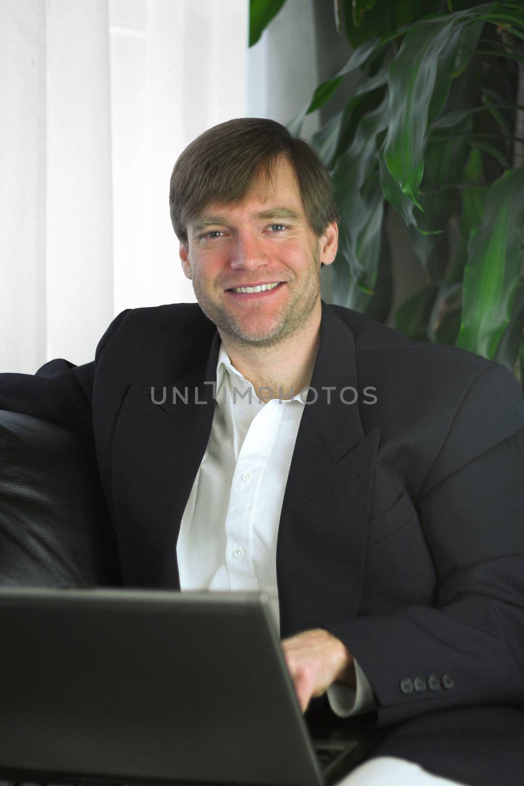 Handsome businessman working on laptop