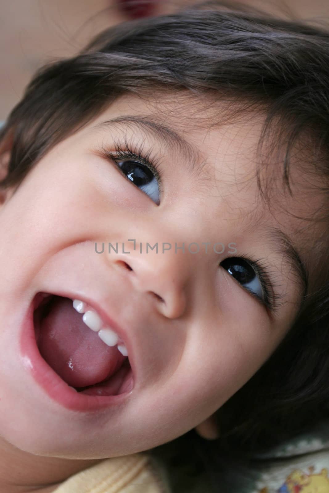 Happy and excited little boy, mouth wide open looking up