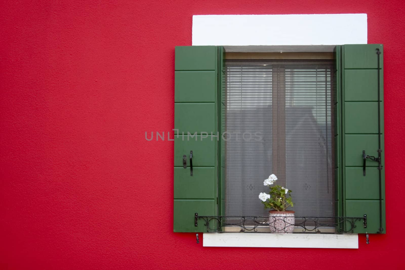 Bright red window frame in the Venetian town of Burano