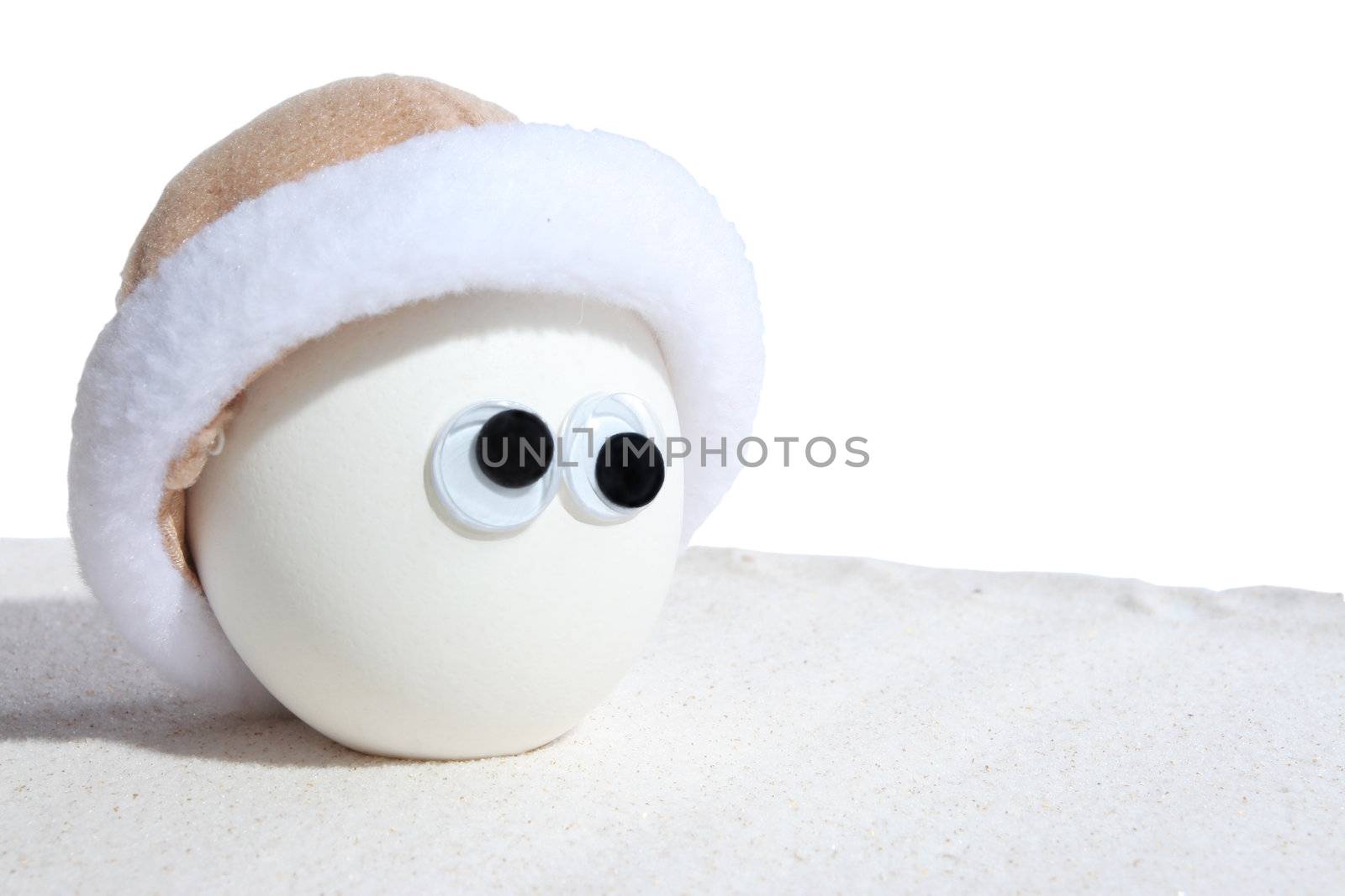 Egg with eyeballs and cap standing on sand. Add own expressions