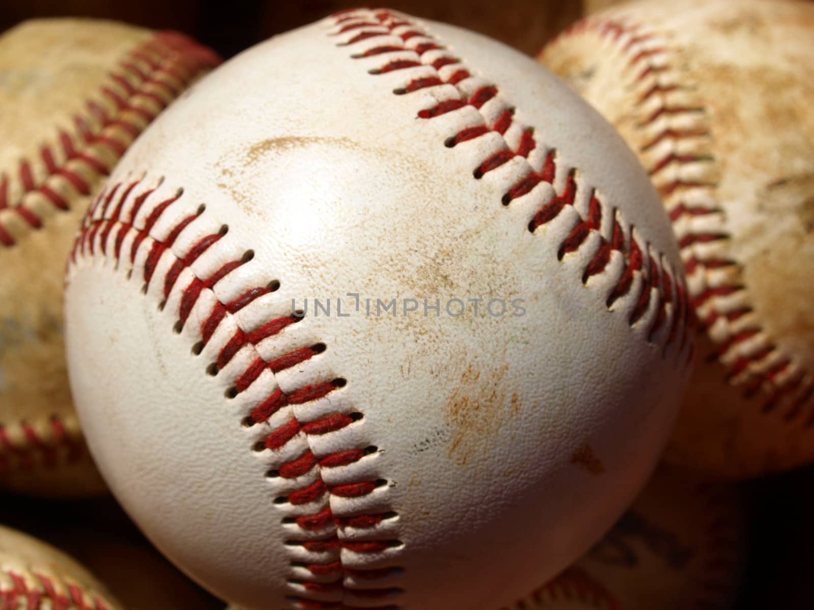 Old baseballs in a bucket after long season