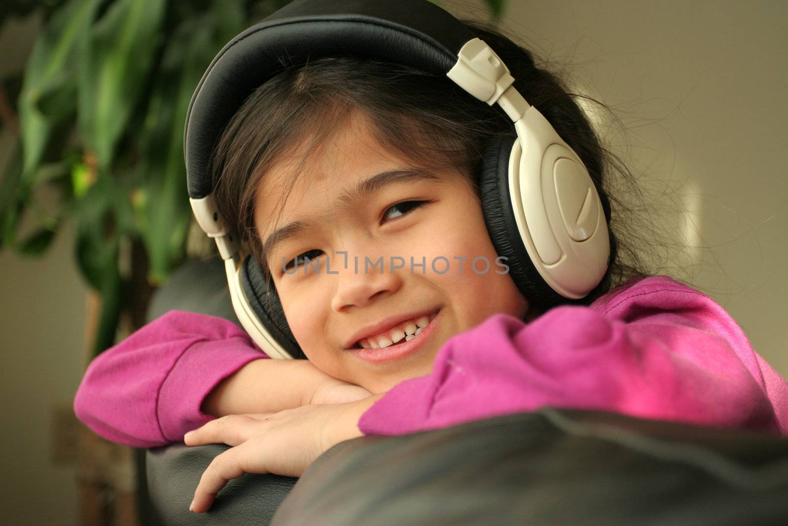 Six year old listening to music with headphones