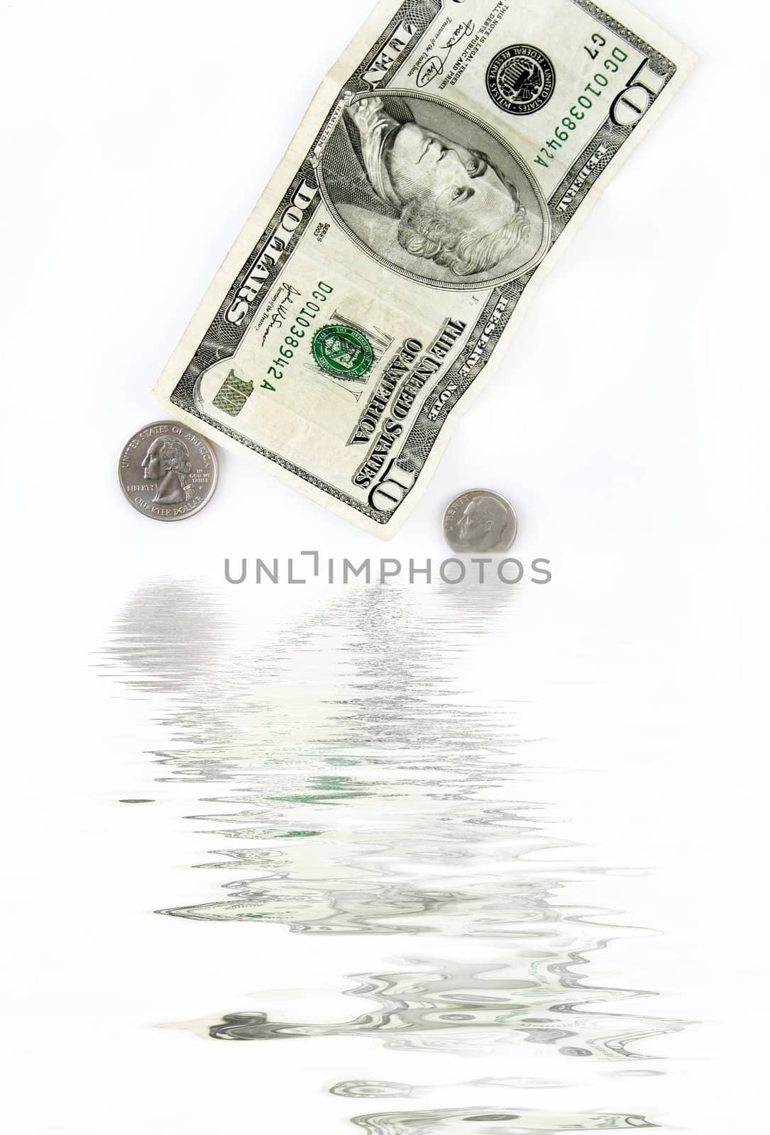 Ten dollar bill and loose change going into water.  Concept of a sinking economy.