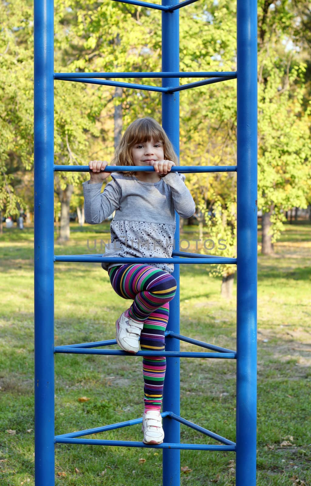 beautiful little girl on playground by goce