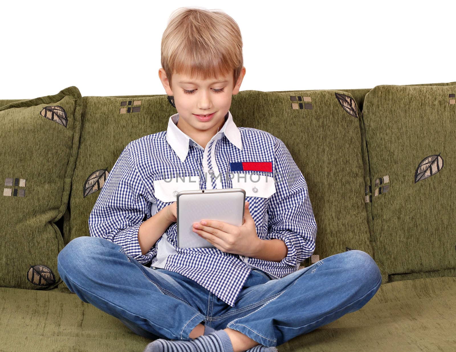 boy sitting on bed and play with tablet pc