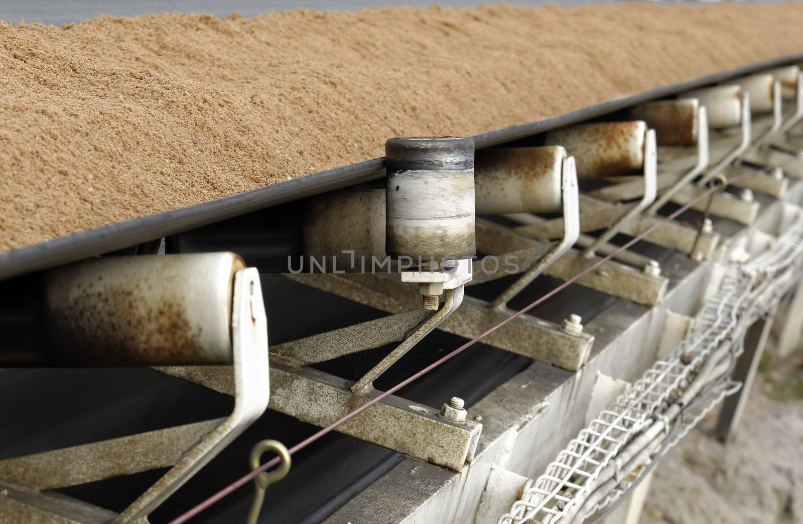 conveyor belt covered with sand