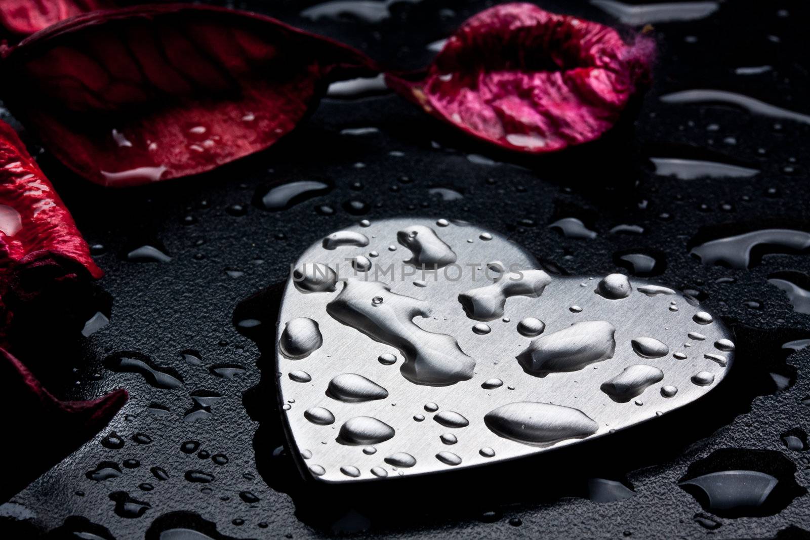 metal heart on a black wet background