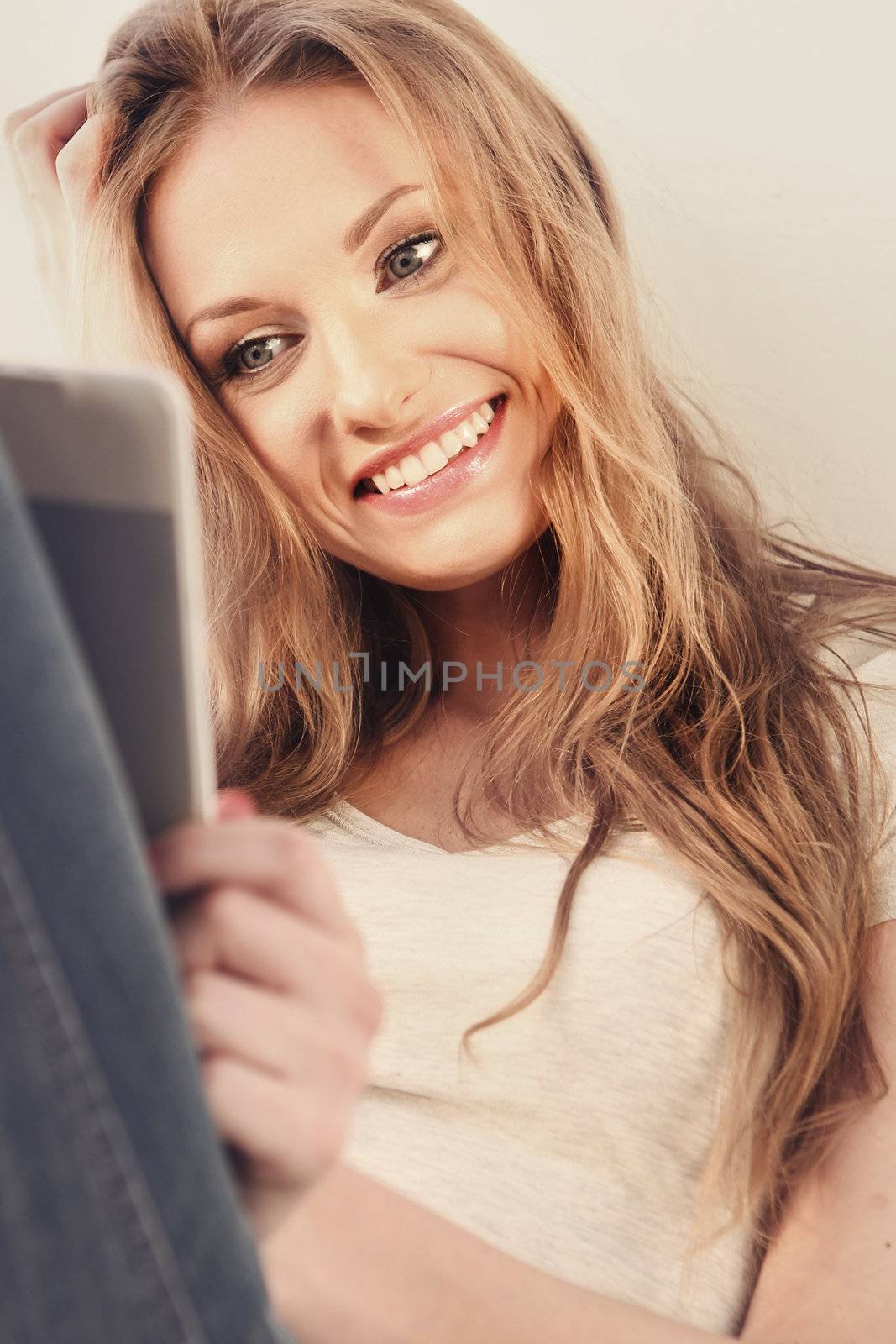 Beautiful girl reading e-book
